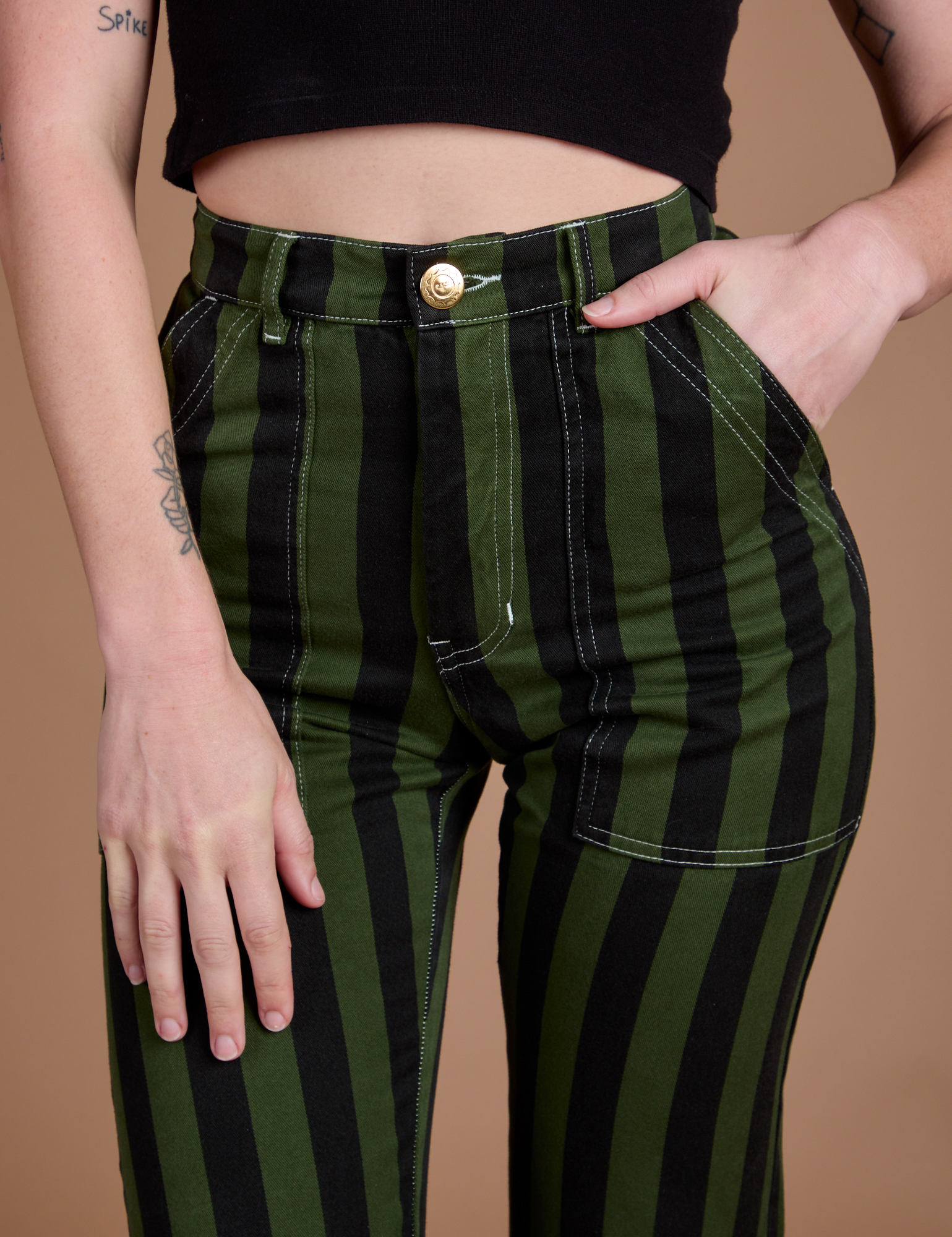 Close up of Alex's hand in the front pocket of Black Stripe Work Pants in Evergreen