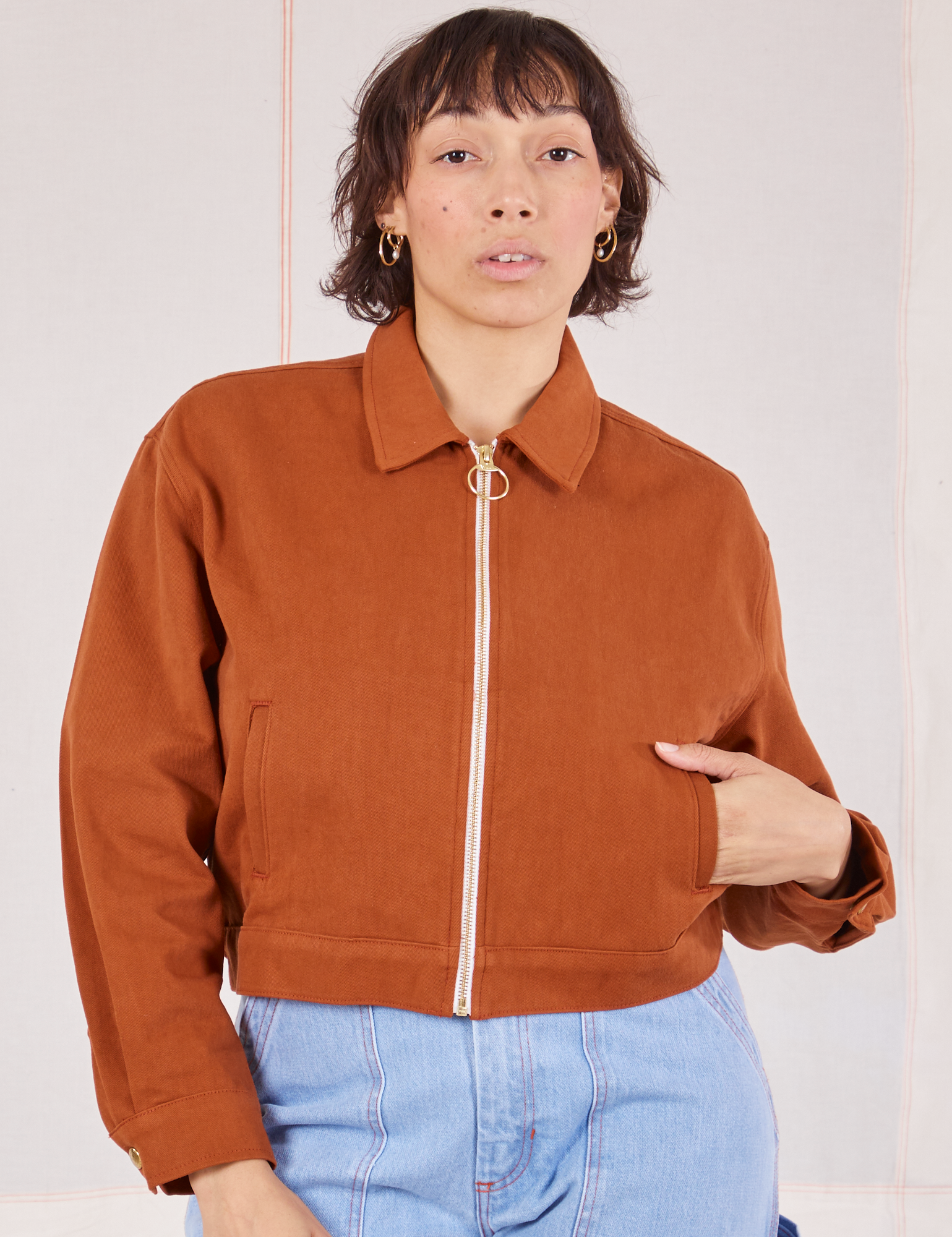 Tiara is wearing a zipped up Ricky Jacket in Burnt Terracotta