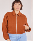 Tiara is wearing a zipped up Ricky Jacket in Burnt Terracotta