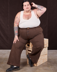Sam is wearing Overdyed Wide Leg Trousers in Brown and vintage off-white Tank Top