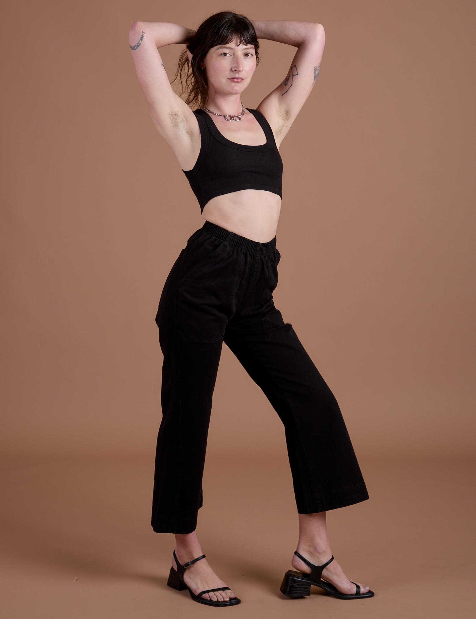 Angled front view of Action Pants in Basic Black on Alex