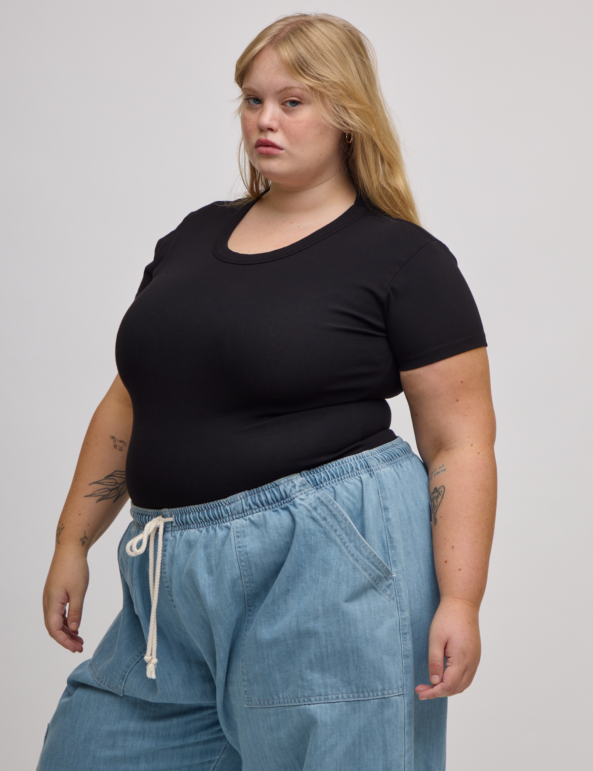 Angled front view of Baby Tee in Basic Black on Juliet
