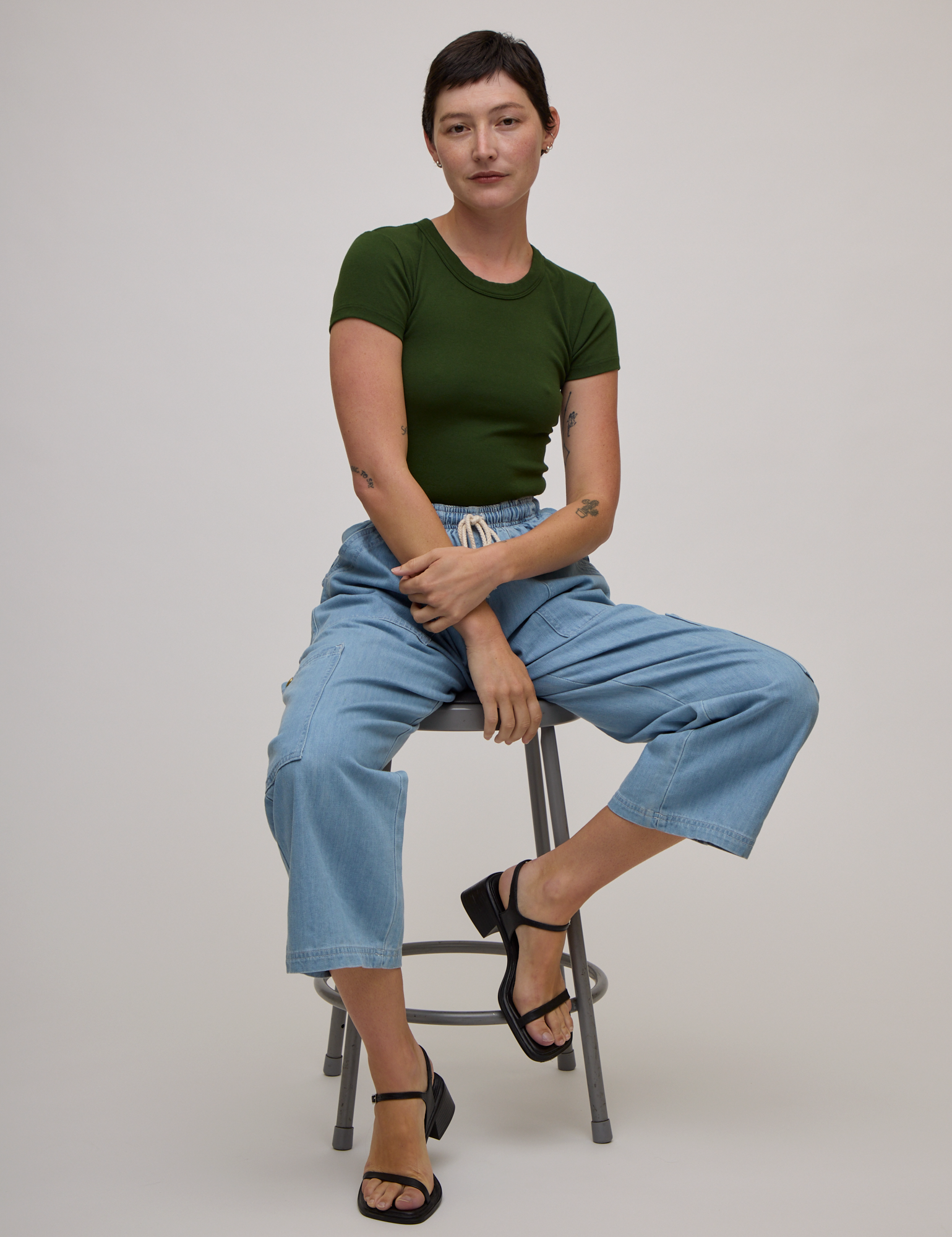 Baby Tee in Evergreen and light wash denim drop pocket pants on Alex