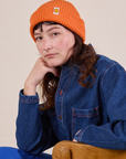 Alex is wearing Ribbed Beanie in Construction Orange