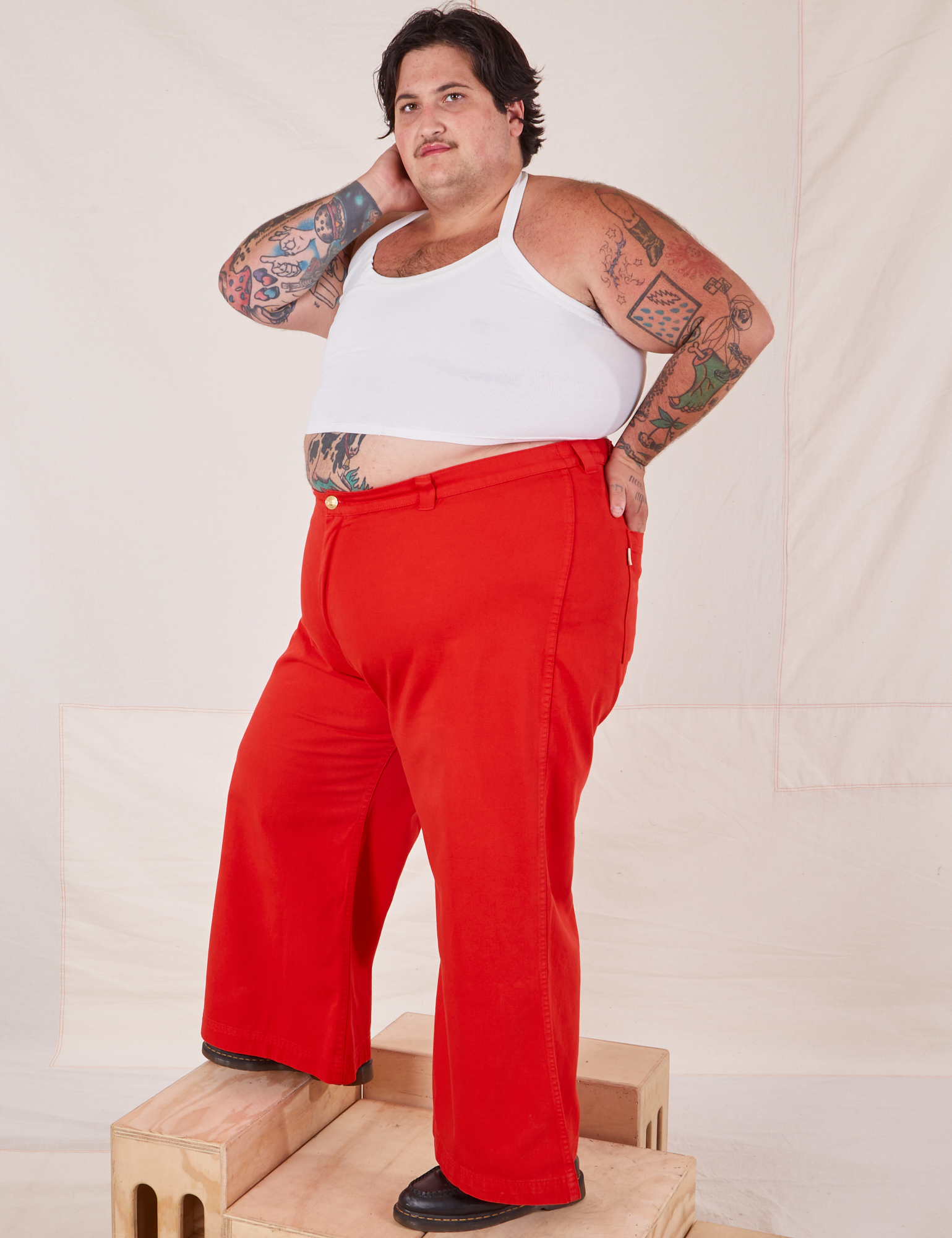 Side view of Bell Bottoms in Mustang Red and vintage off-white Halter Top worn by Sam