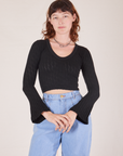 Alex is wearing P Bell Sleeve Top in Basic Black paired with light wash Trouser Jeans