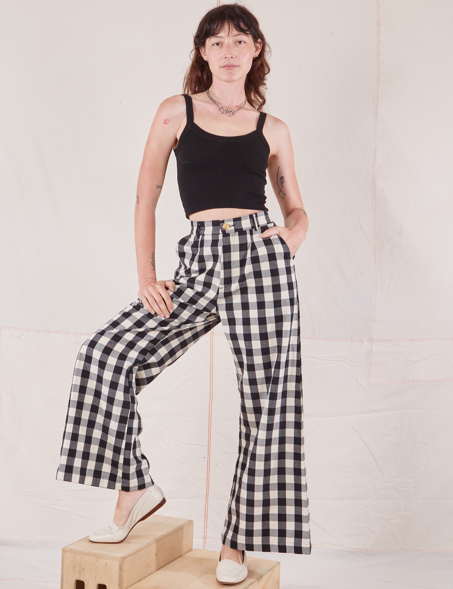 Alex is wearing Wide Leg Trousers in Big Gingham and black Cropped Cami