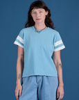 Alex is 5’8” and wearing P Painted Burly Tee in Baby Blue