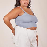 Angled view of Cropped Cami in Periwinkle and vintage off-white Western Pants worn by Alicia