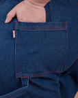 Close up of Ashley's hand in the back pocket of Carpenter Jeans in Dark Wash