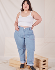 Ashley is 5'7" and wearing 1XL Carpenter Jeans in Light Wash paired with vintage off-white Cropped Cami