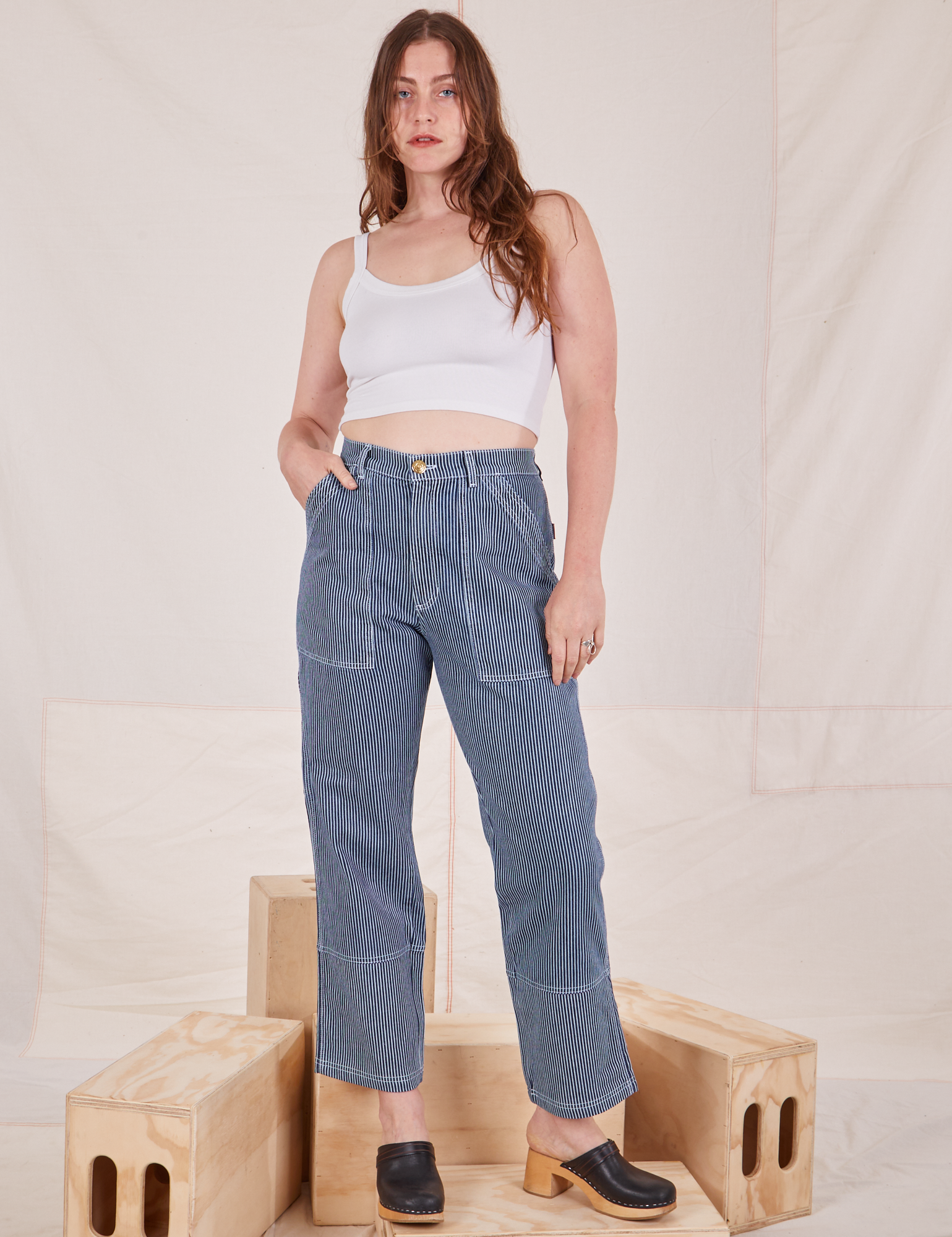 Allison is 5&#39;10&quot; and wearing S Carpenter Jeans in Railroad Stripes paired with vintage off-white Cami