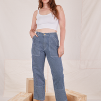 Allison is 5'10" and wearing S Carpenter Jeans in Railroad Stripes paired with vintage off-white Cami