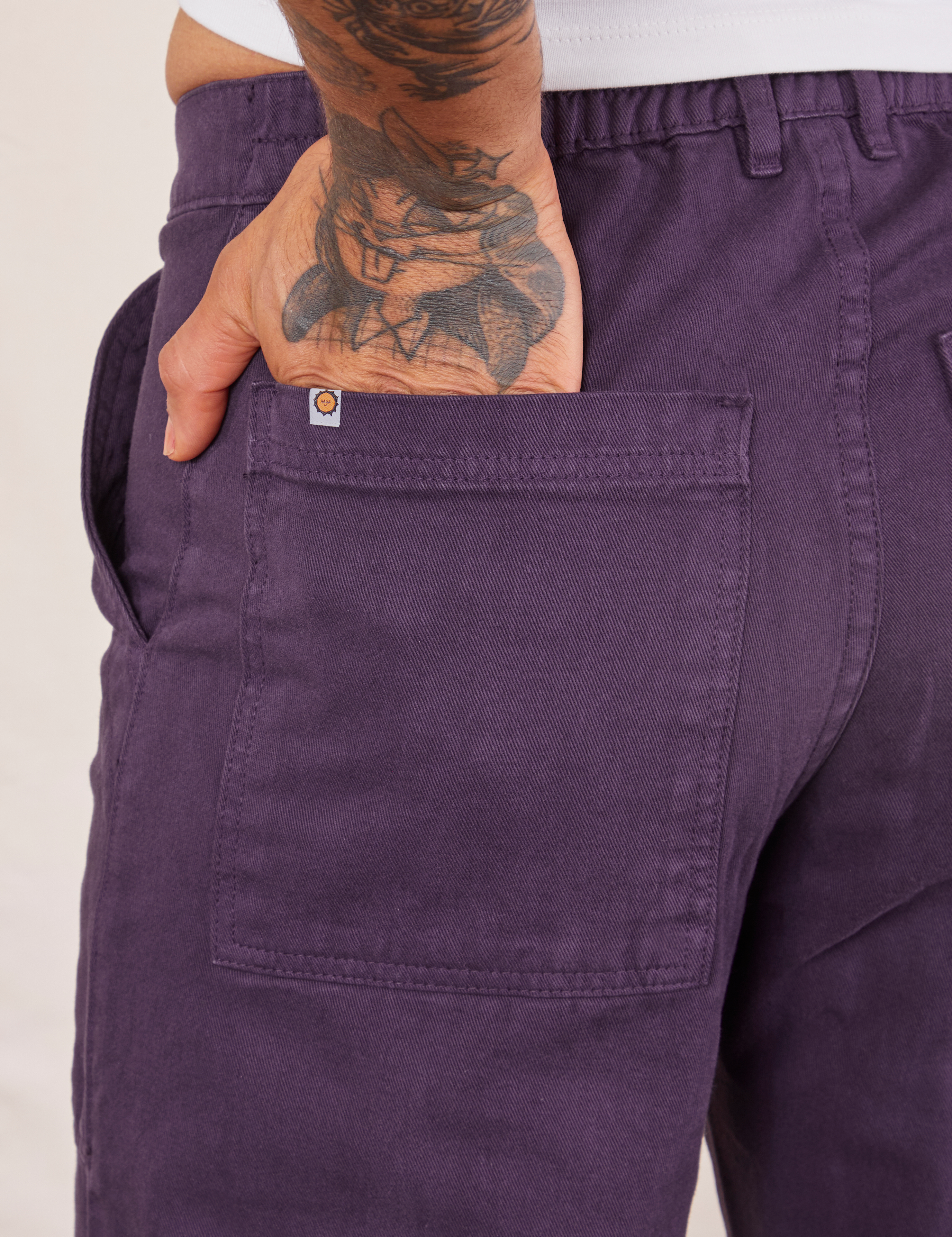 Back pocket close up of Work Pants in Nebula Purple worn by Jesse