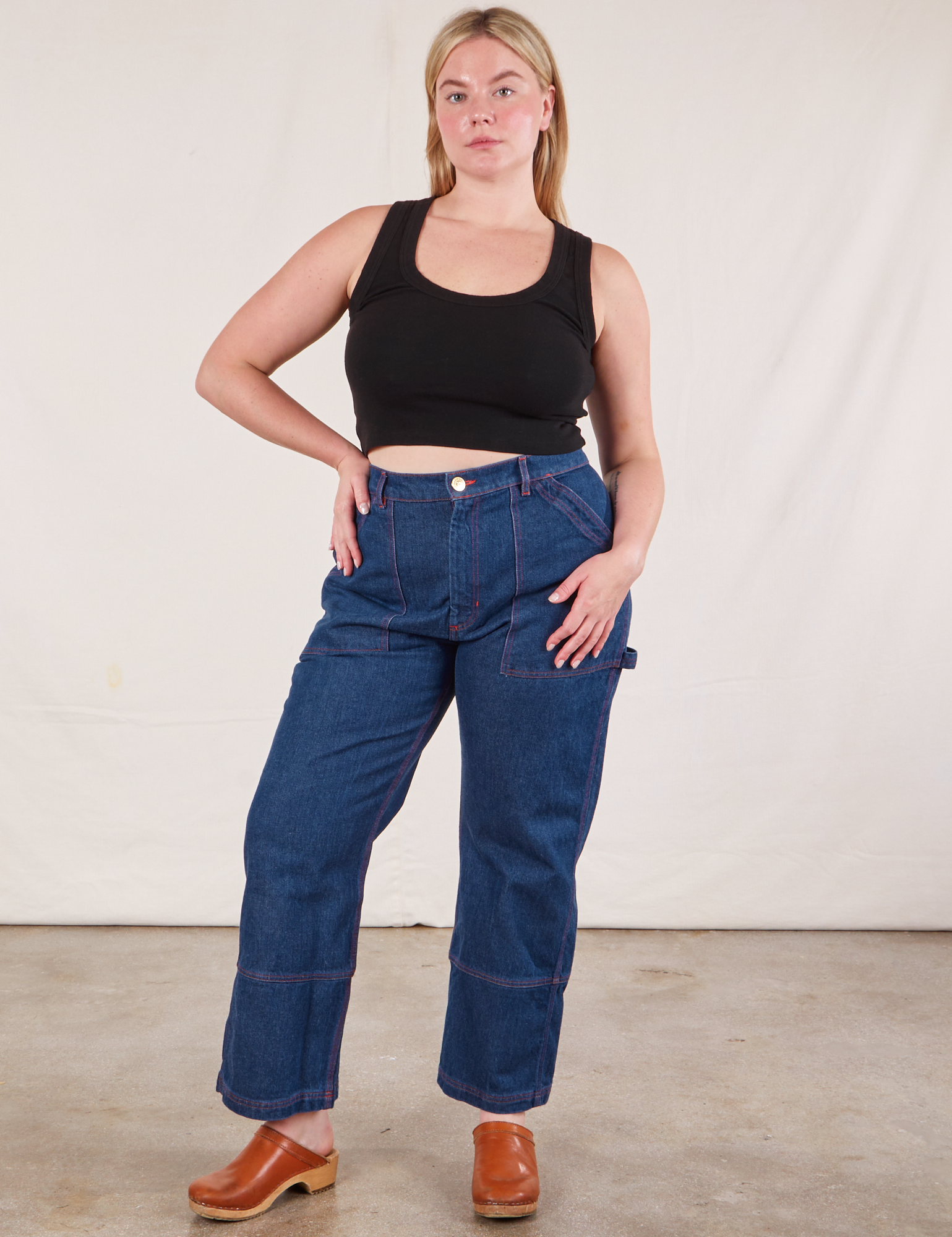 Lish is wearing Cropped Tank Top in Basic Black and dark wash Carpenter Jeans