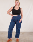 Lish is wearing Cropped Tank Top in Basic Black and dark wash Carpenter Jeans