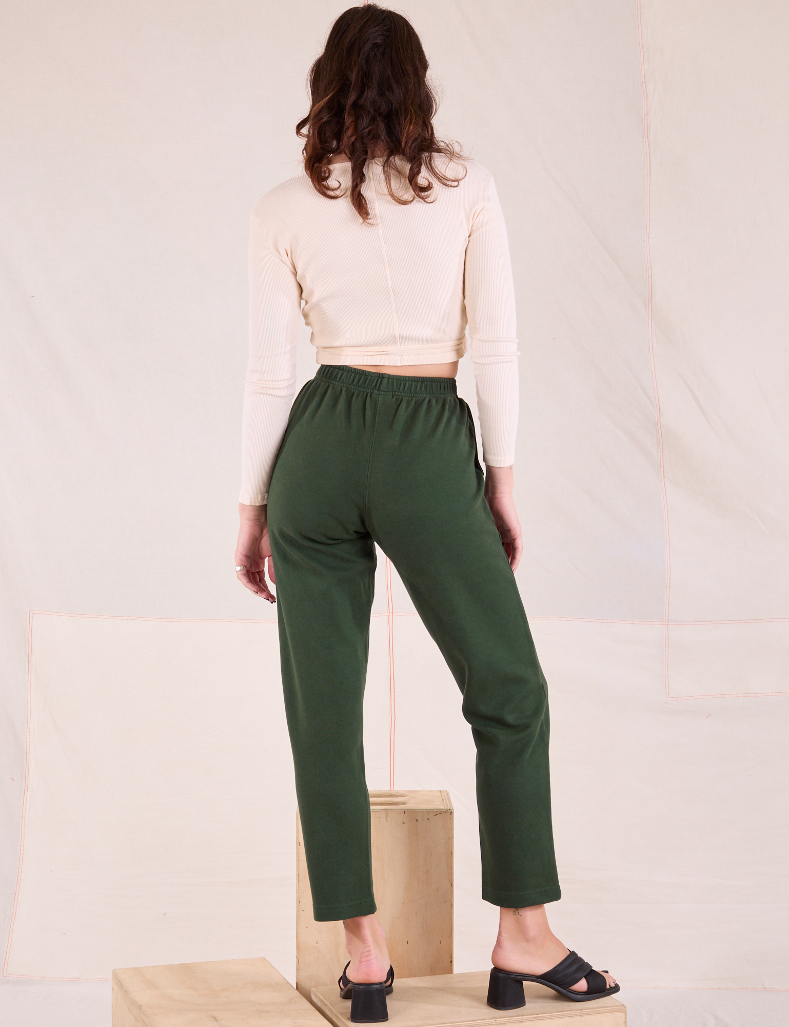 Back view of Easy Pants in Swamp Green and vintage tee off-white Wrap Top on Alex