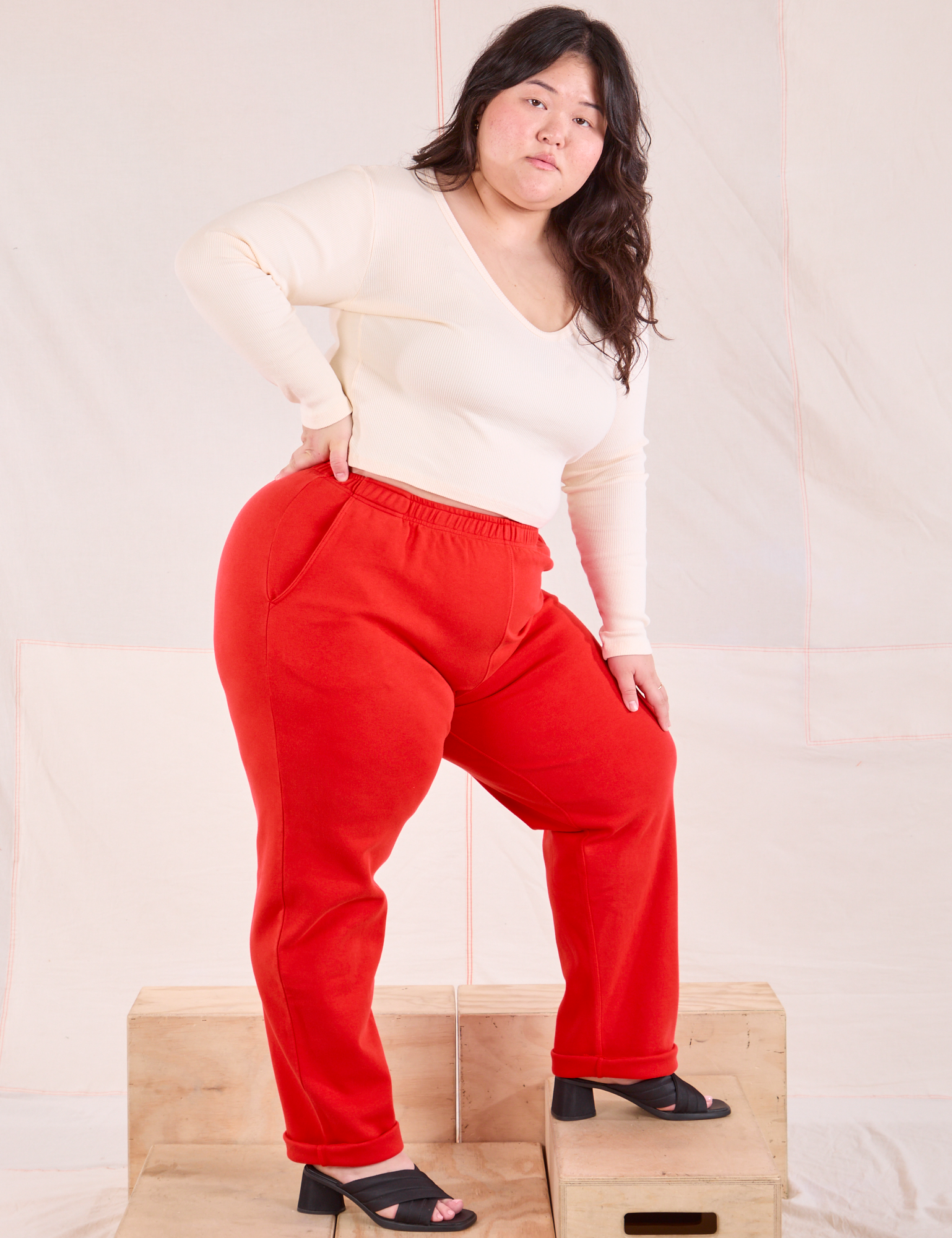 Side view of Easy Pants in Mustang Red and vintage tee off-white Wrap Top on Ashley