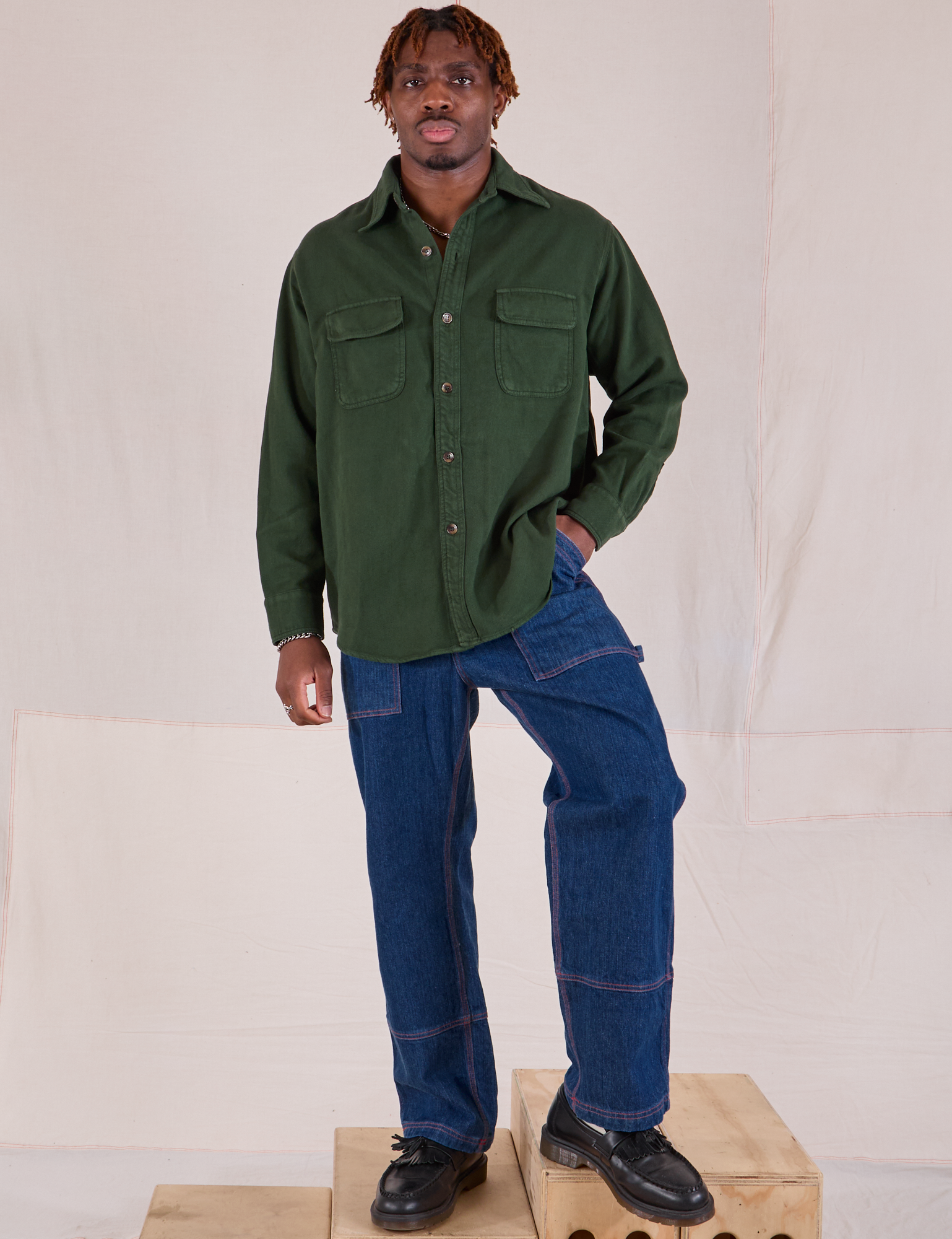 Flannel Overshirt in Swamp Green and dark wash Carpenter Jeans worn by Isaac