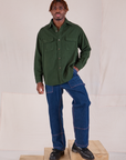 Flannel Overshirt in Swamp Green and dark wash Carpenter Jeans worn by Isaac