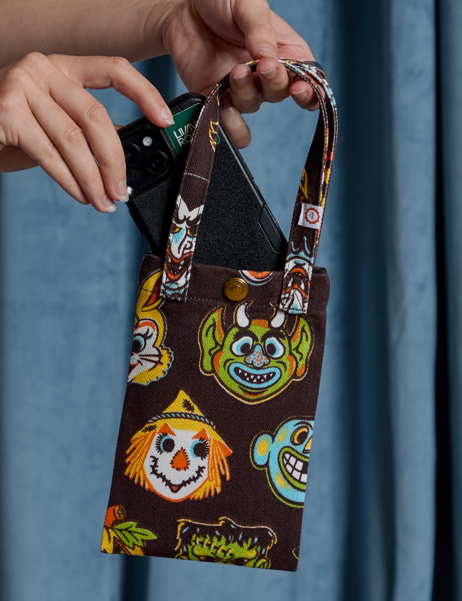 Halloween Masks Cell Phone Tote with Alex tucking in a phone