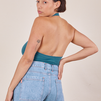 Angled back view of Halter Top in Marine Blue and light wash Sailor Jeans worn by Tiara