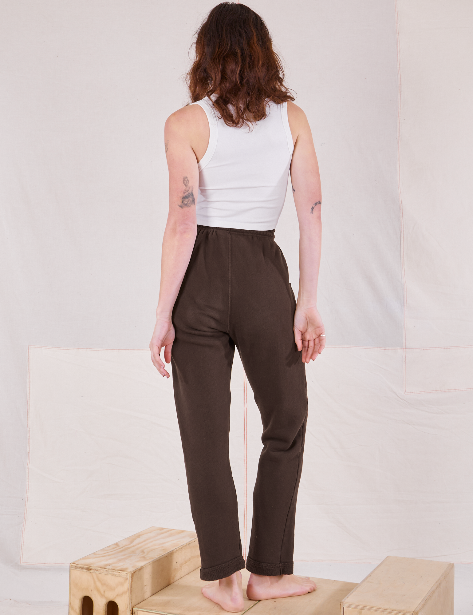 Back view of Rolled Cuff Sweat Pants in Espresso Brown and vintage off-white Cropped Tank on Alex