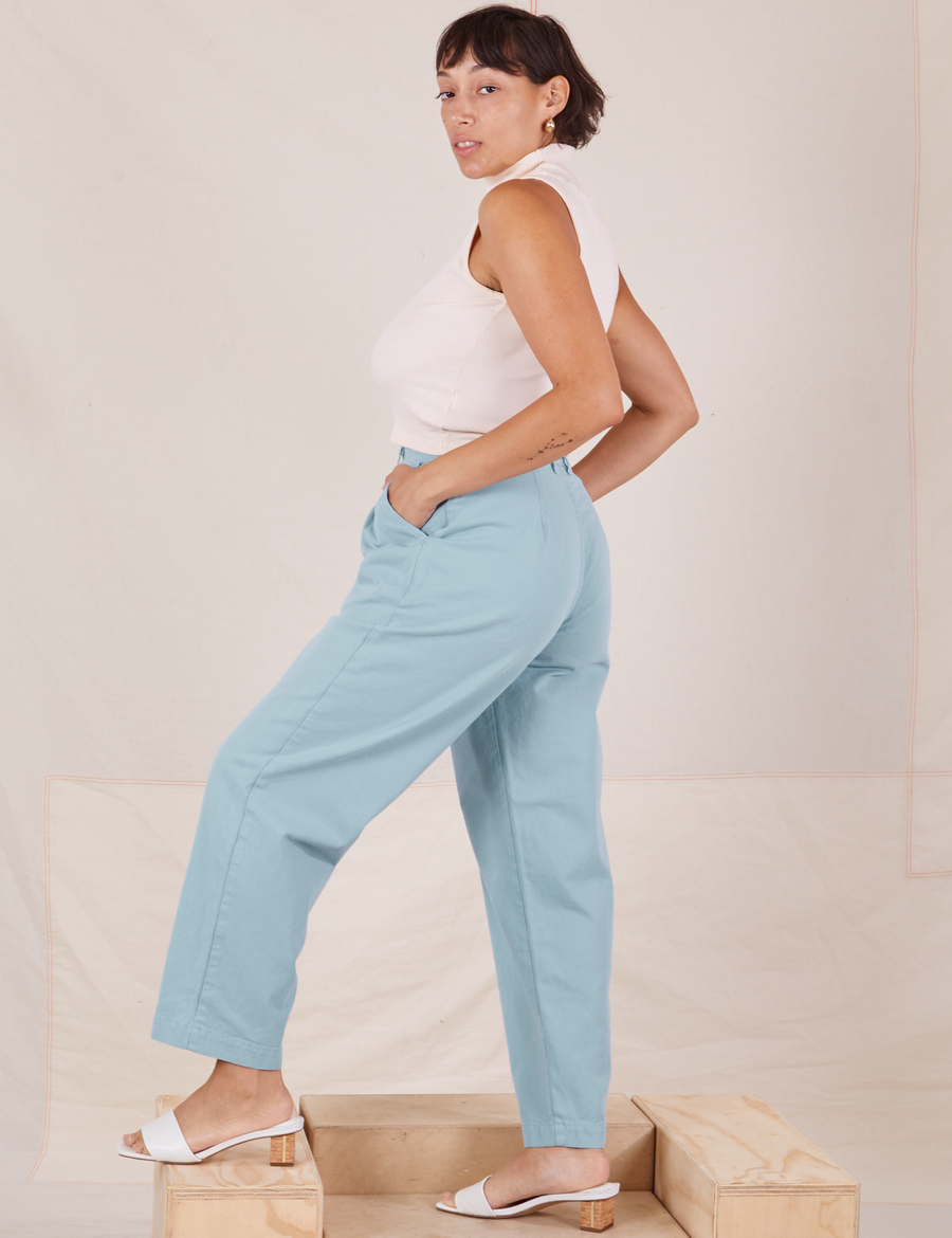 Side view of Heavyweight Trousers in Baby Blue and vintage off-white Sleeveless Turtleneck worn by Tiara