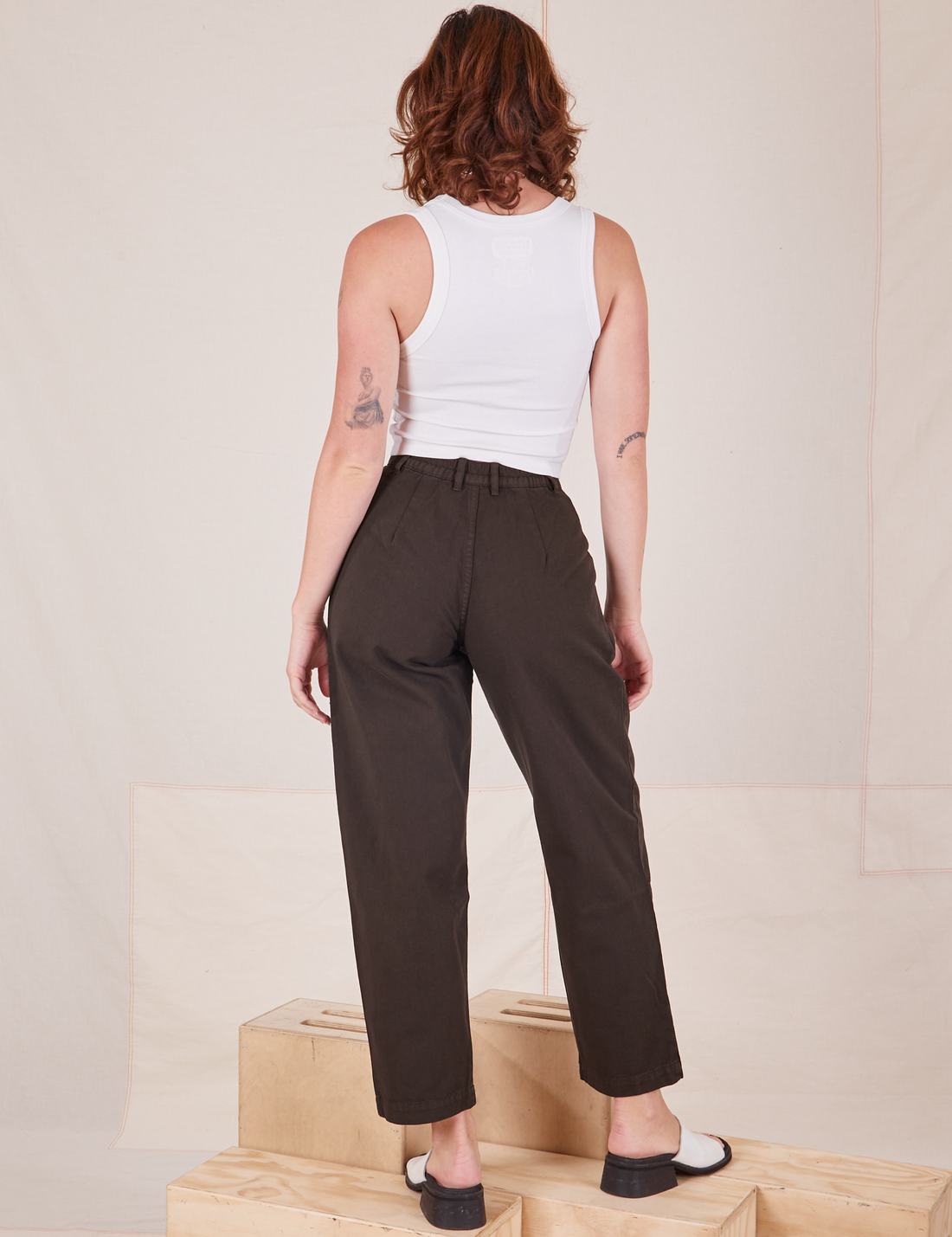 Back view of Heavyweight Trousers in Espresso Brown and vintage off-white Cropped Tank Top worn by Alex