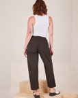 Back view of Heavyweight Trousers in Espresso Brown and vintage off-white Cropped Tank Top worn by Alex