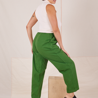 Angled back view of Heavyweight Trousers in Lawn Green and vintage off-white Sleeveless Turtleneck worn by Tiara