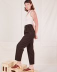 Side view of Heritage Trousers in Espresso Brown and vintage off-white Tank Top worn by Alex