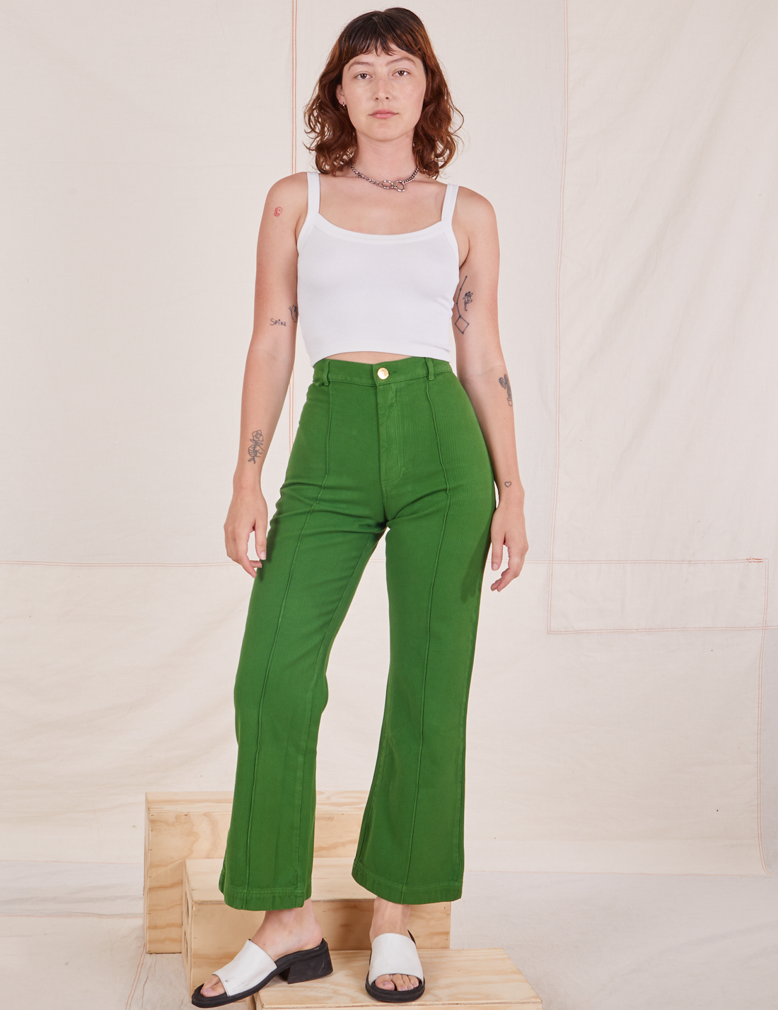 Alex is wearing Heritage Westerns in Lawn Green and vintage off-white Cropped Cami