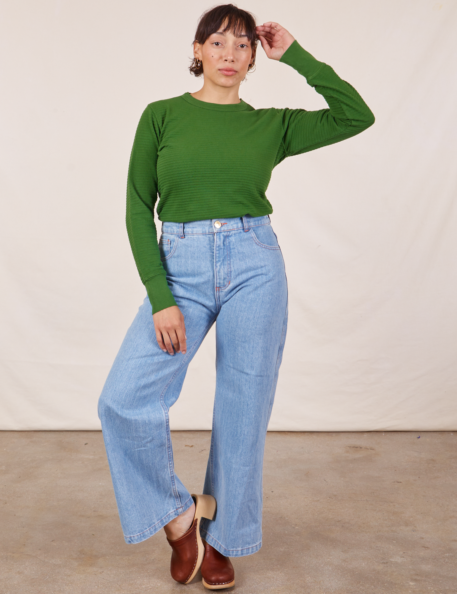 Tiara is wearing Honeycomb Thermal in Lawn Green tucked into light wash Sailor Jeans