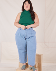 Ashley is wearing Sleeveless Essential Turtleneck in Hunter Green and light wash Trouser Jeans