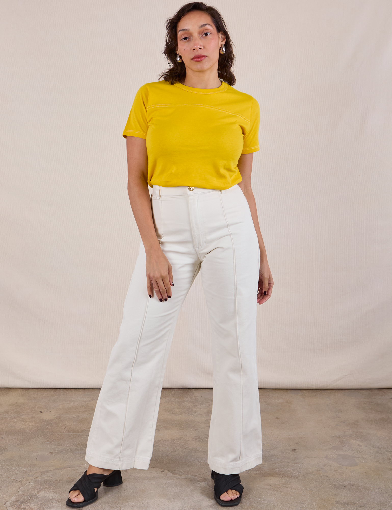 Tiara is wearing JV Tee in Golden Yellow tucked into vintage tee off-white Western Pants