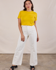 Tiara is wearing JV Tee in Golden Yellow tucked into vintage tee off-white Western Pants