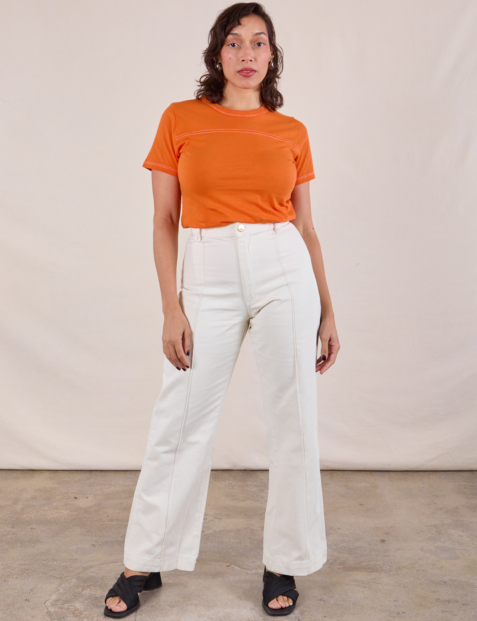 JV Tee in Construction Orange and vintage tee off-white Western Pants worn by Tiara