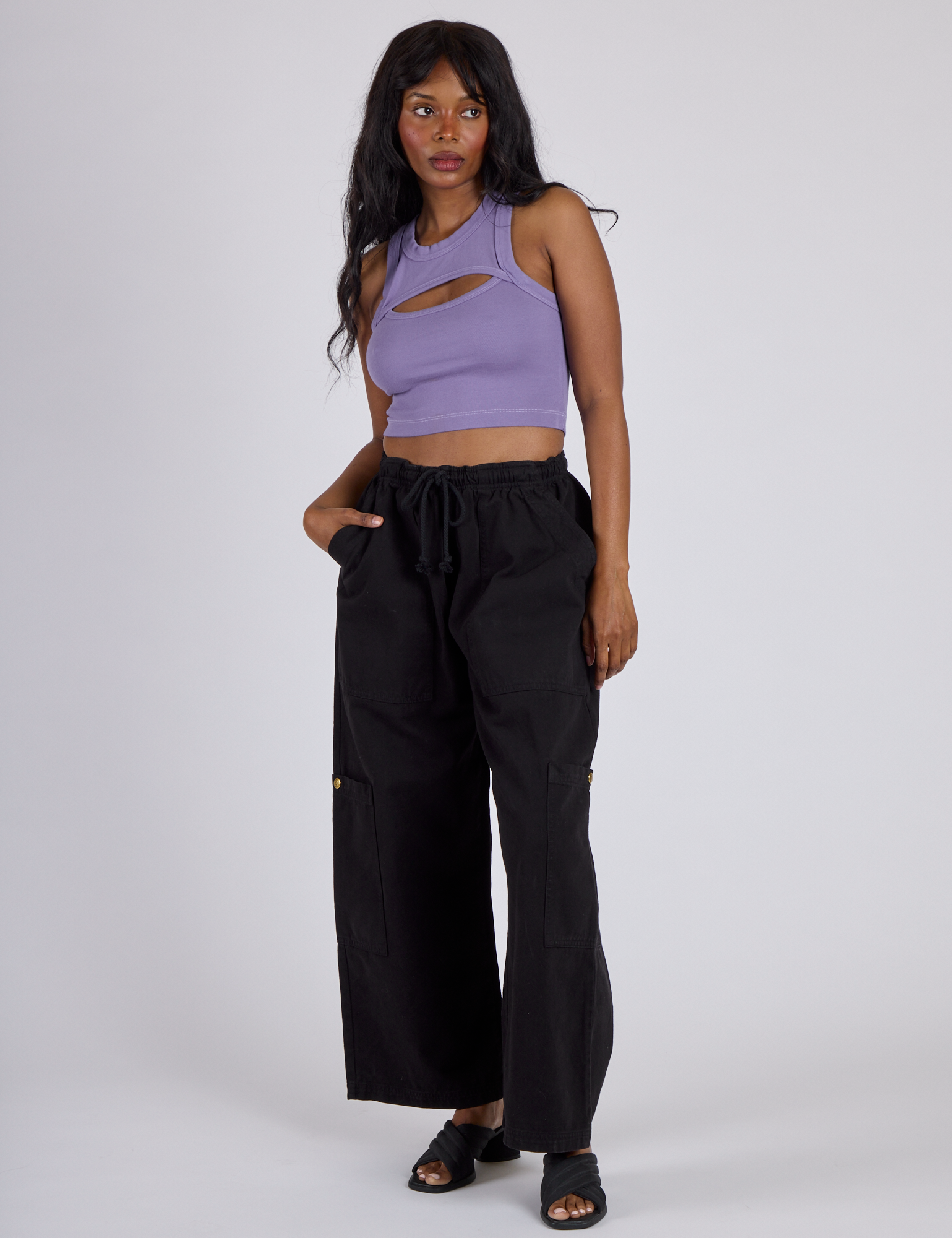 Kandia is wearing the Faded Grape Porthole Tank with Black Drop Pocket Cargo Pants