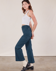 Side view of Western Pants in Lagoon and vintage tee off-white Cropped Tank on Alex