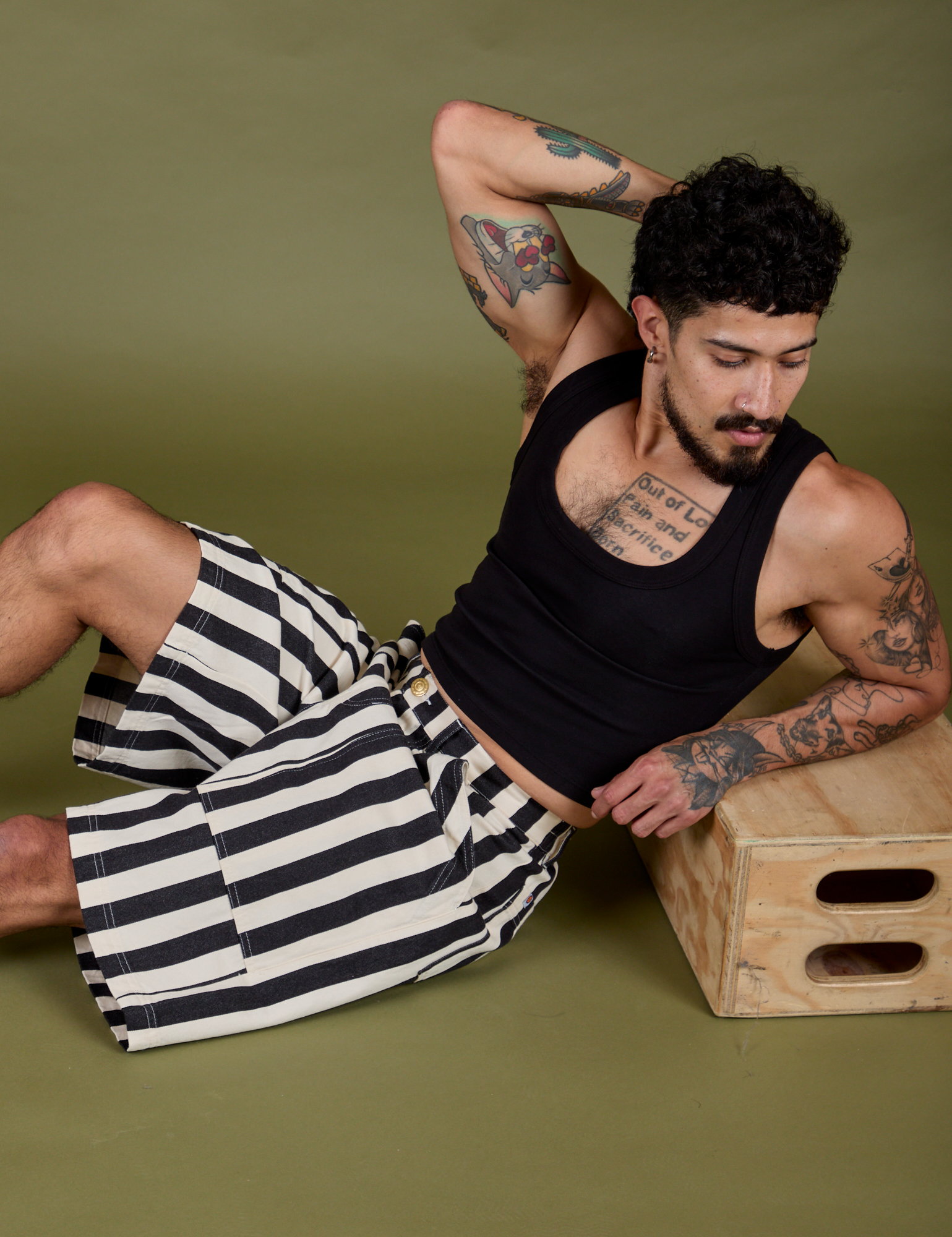 Jesse is wearing Longline Work Shorts in Natural and black Cropped Tank