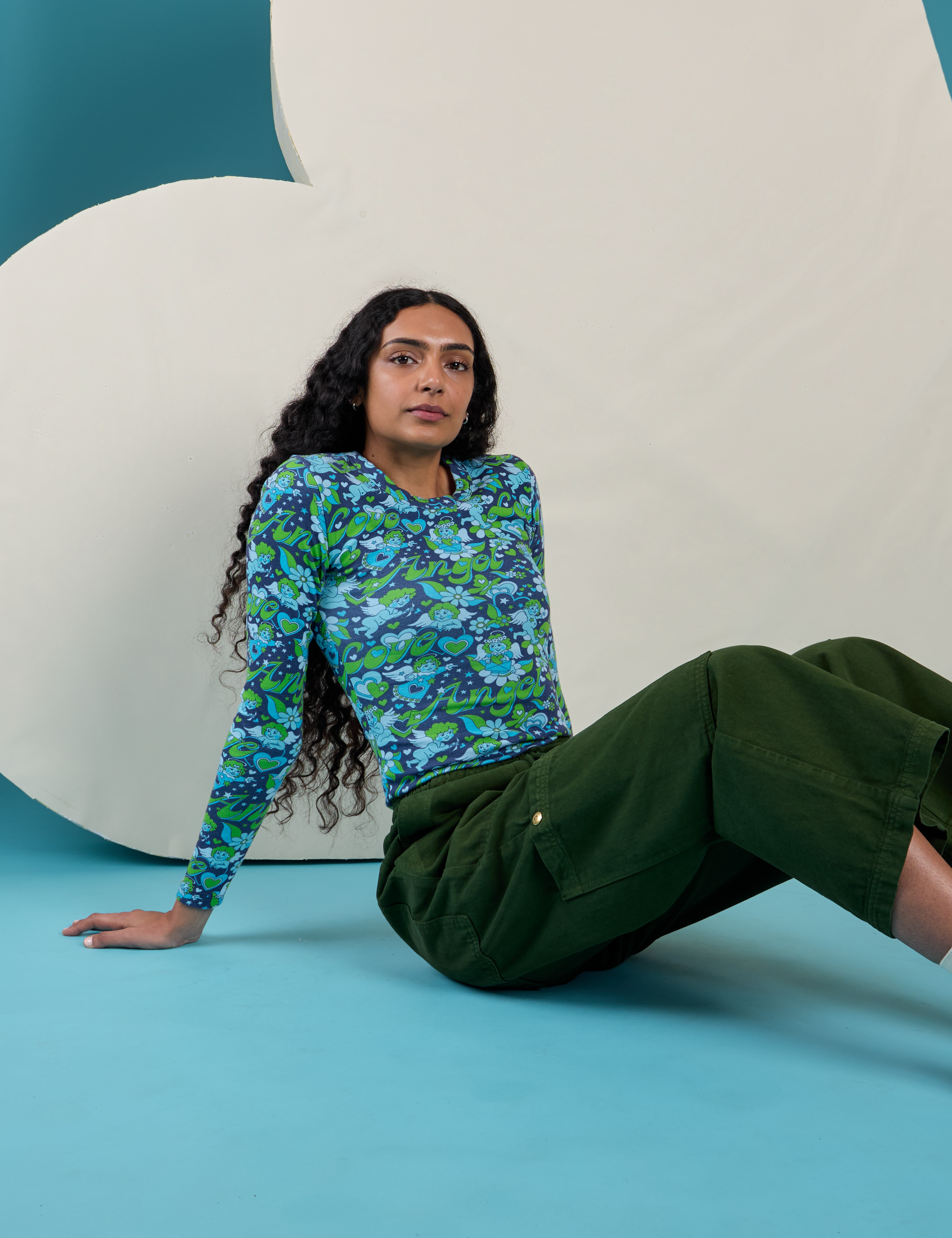 Shahana is wearing Long Sleeve Baby Tee in Angel Print and Drop Pocket Cargo Pants in Evergreen