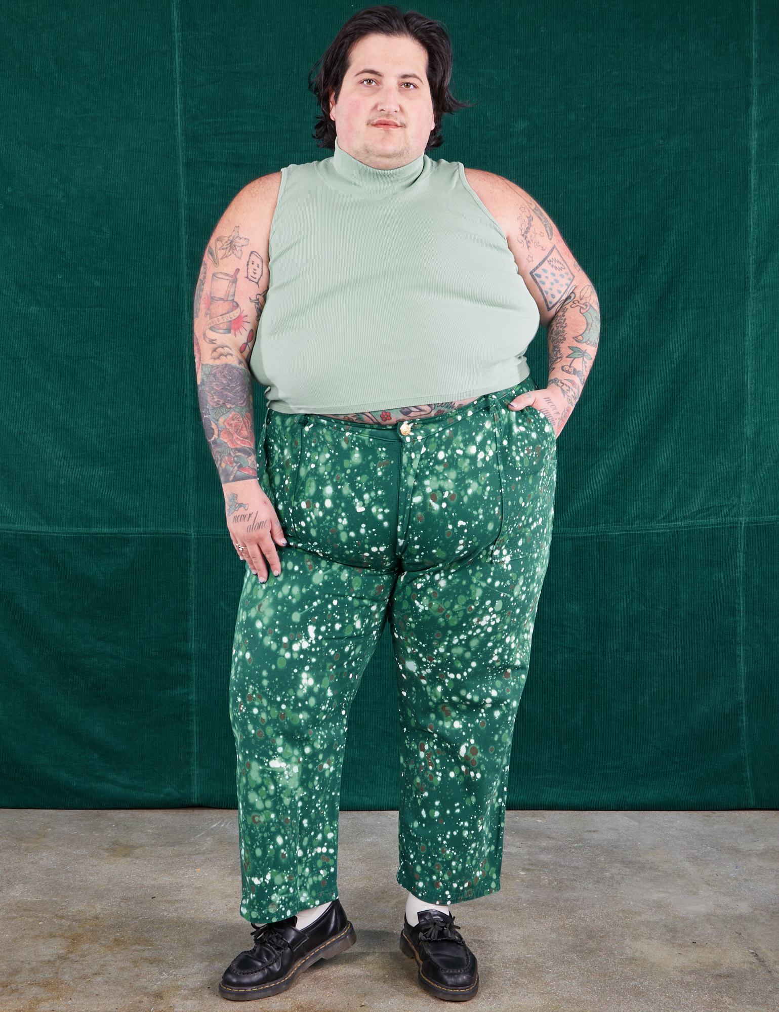 Sam is 5&#39;10&quot; and wearing 3XL Marble Splatter Work Pants in Hunter Green paired with sage green Sleeveless Turtleneck