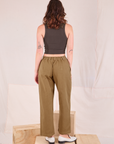 Back view of Mid-Rise Pleated Trousers in Desert Brown and espresso brown Cropped Tank on Alex