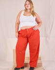 Juliet is wearing Mid-Rise Pleated Trousers in Chili Red and Cropped Tank in vintage tee off-white