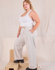 Side view of Mid-Rise Pleated Trousers in Stone White and Cropped Tank in vintage tee off-white