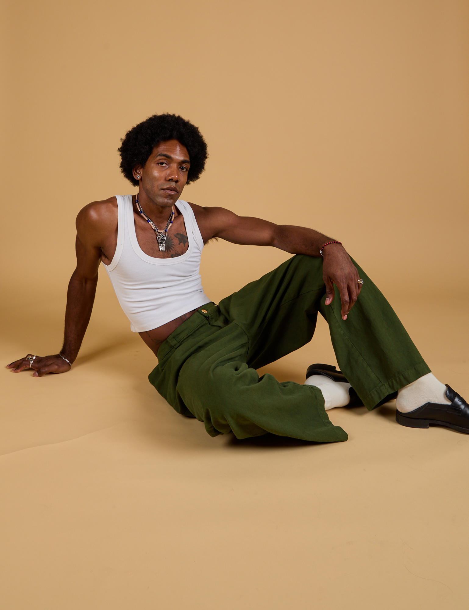 Baggy Mid-Rise Trousers in Evergreen and vintage tee white Cropped Tank on Jerrod
