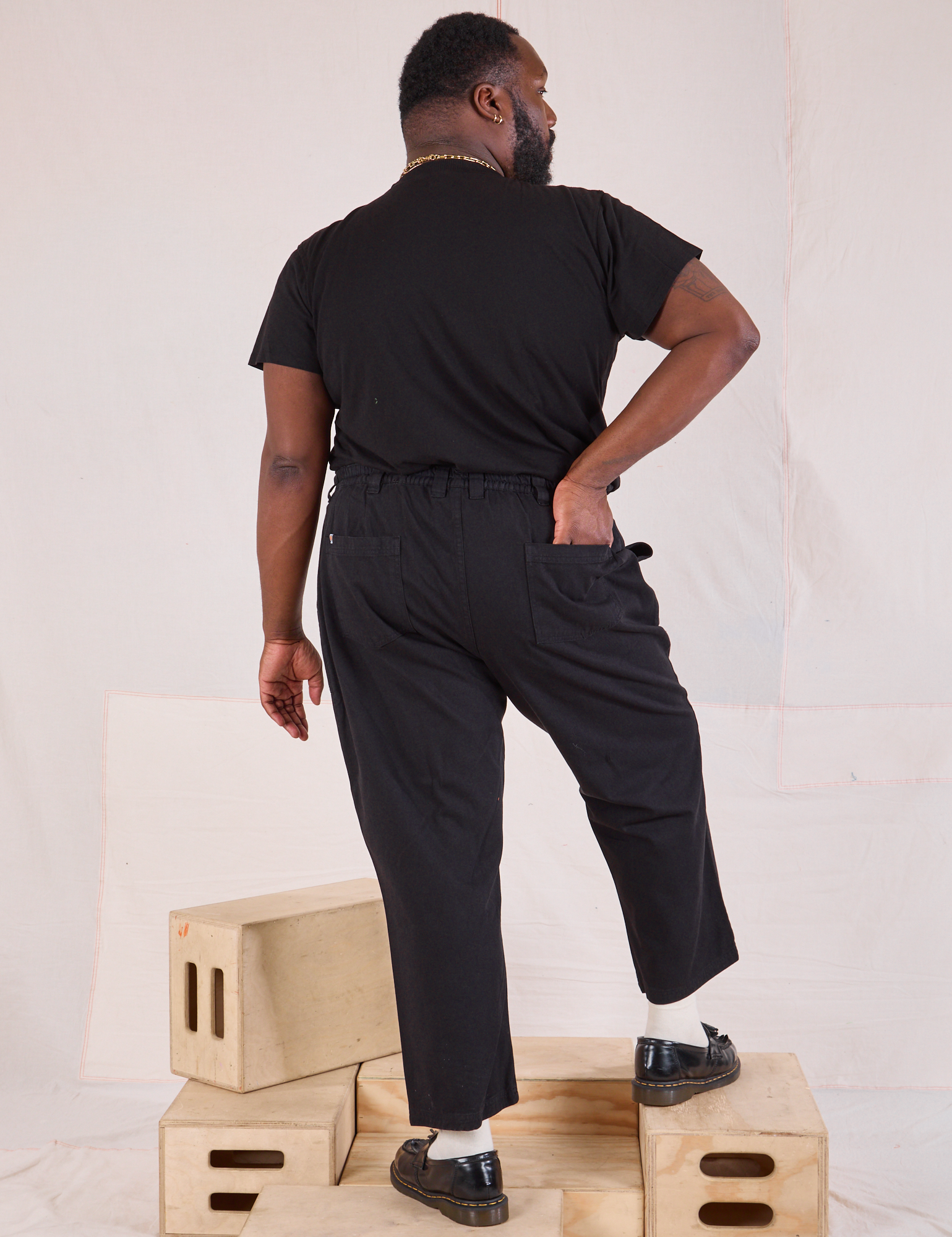 Back view of Mid-Rise Work Pants in Basic Black and black Organic Vintage Tee on Elijah