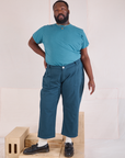 Elijah is 6'3" and wearing 1XL Mid-Rise Work Pants in Lagoon paired with marine blue Organic Vintage Tee