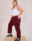 Side view of Mid-Rise Work Pants in Red Wine and Cropped Tank in vintage tee off-white on Juliet